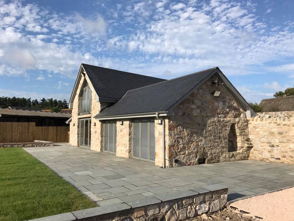 RAL 9007 grey aluminium windows and bi-folding doors in barn conversion
